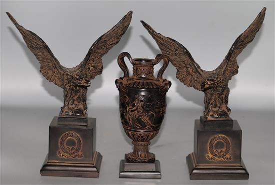 A classical vase on stand and a pair of eagles on stands